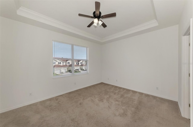 1156 Jonah Dr, North Port, FL 34289 - empty room featuring a ceiling fan, a raised ceiling, light carpet, and crown molding