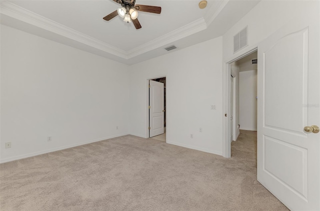 1156 Jonah Dr, North Port, FL 34289 - empty room featuring a tray ceiling, visible vents, crown molding, and light carpet