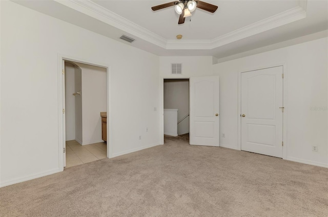 1156 Jonah Dr, North Port, FL 34289 - unfurnished bedroom featuring a tray ceiling, light colored carpet, visible vents, and crown molding