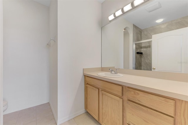 1156 Jonah Dr, North Port, FL 34289 - bathroom featuring a stall shower, toilet, vanity, tile patterned flooring, and baseboards