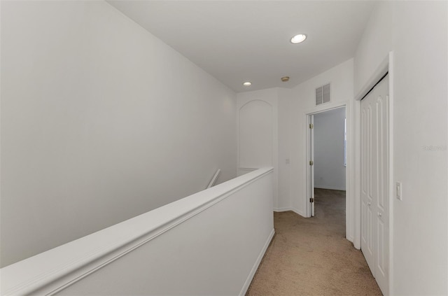 1156 Jonah Dr, North Port, FL 34289 - hallway with an upstairs landing, visible vents, baseboards, recessed lighting, and light colored carpet