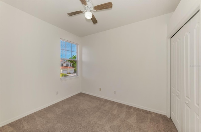 1156 Jonah Dr, North Port, FL 34289 - unfurnished bedroom featuring a closet, baseboards, a ceiling fan, and light carpet