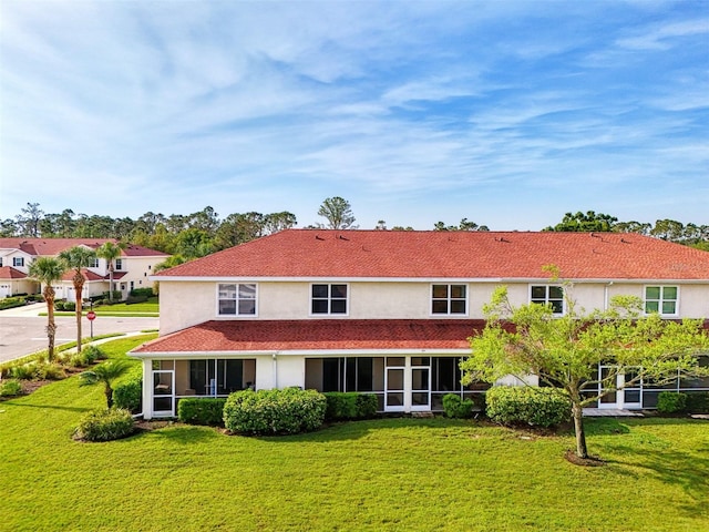 1156 Jonah Dr, North Port, FL 34289 - rear view of property featuring stucco siding, a sunroom, and a yard
