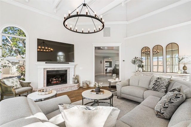 310 Severin Rd SE, Port Charlotte, FL 33952 - living room featuring an inviting chandelier, a towering ceiling, wood finished floors, and a fireplace