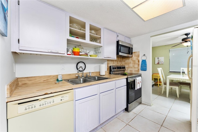 4022 Beaver Ln Unit 500C, Port Charlotte, FL 33952 - kitchen with stainless steel appliances, a sink, light tile patterned floors, light countertops, and a ceiling fan