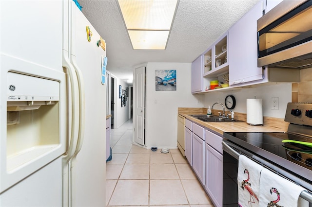 4022 Beaver Ln Unit 500C, Port Charlotte, FL 33952 - kitchen with stainless steel appliances, light tile patterned floors, a sink, a textured ceiling, and open shelves