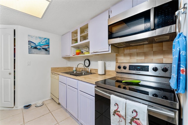 4022 Beaver Ln Unit 500C, Port Charlotte, FL 33952 - kitchen featuring appliances with stainless steel finishes, a sink, backsplash, light tile patterned flooring, and open shelves
