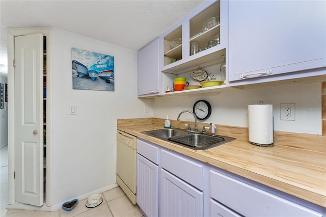 4022 Beaver Ln Unit 500C, Port Charlotte, FL 33952 - kitchen featuring white dishwasher, a sink, butcher block countertops, light tile patterned floors, and open shelves