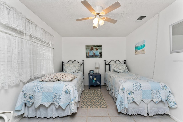 4022 Beaver Ln Unit 500C, Port Charlotte, FL 33952 - tiled bedroom with a textured ceiling and ceiling fan