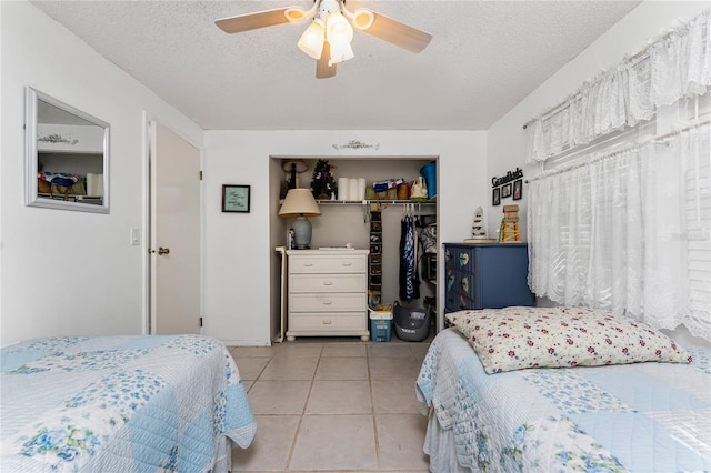 4022 Beaver Ln Unit 500C, Port Charlotte, FL 33952 - tiled bedroom featuring a closet, a textured ceiling, and ceiling fan