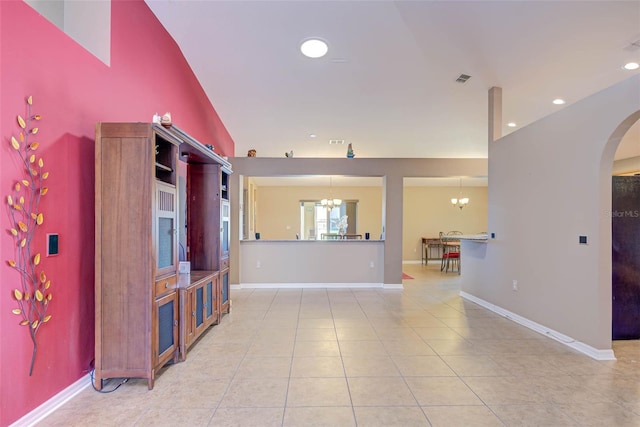 2699 Suncoast Lakes Blvd, Punta Gorda, FL 33980 - living room with recessed lighting, light tile patterned floors, baseboards, arched walkways, and a notable chandelier
