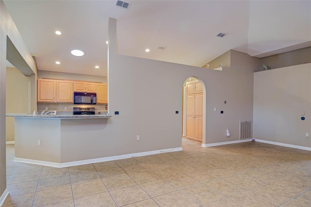 2699 Suncoast Lakes Blvd, Punta Gorda, FL 33980 - kitchen featuring baseboards, stainless steel range with electric cooktop, visible vents, light brown cabinets, and black microwave