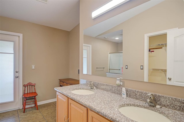 2699 Suncoast Lakes Blvd, Punta Gorda, FL 33980 - bathroom with double vanity, a sink, tile patterned flooring, and a shower with shower door