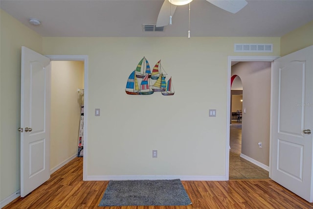 2699 Suncoast Lakes Blvd, Punta Gorda, FL 33980 - spare room featuring wood finished floors, arched walkways, and visible vents