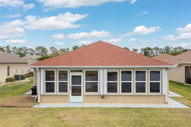 2699 Suncoast Lakes Blvd, Punta Gorda, FL 33980 - back of property with stucco siding, roof with shingles, a patio, central AC unit, and a lawn