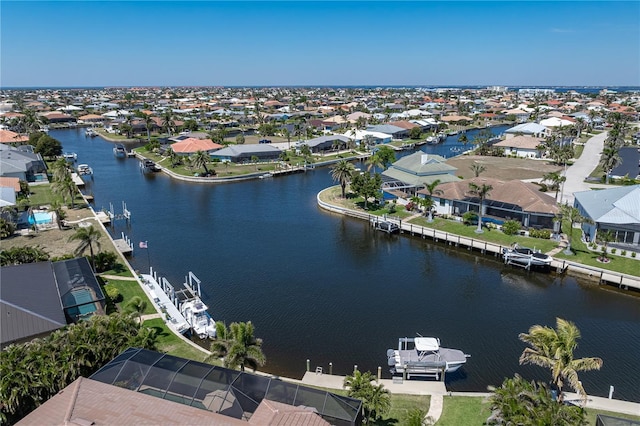 drone / aerial view featuring a residential view and a water view