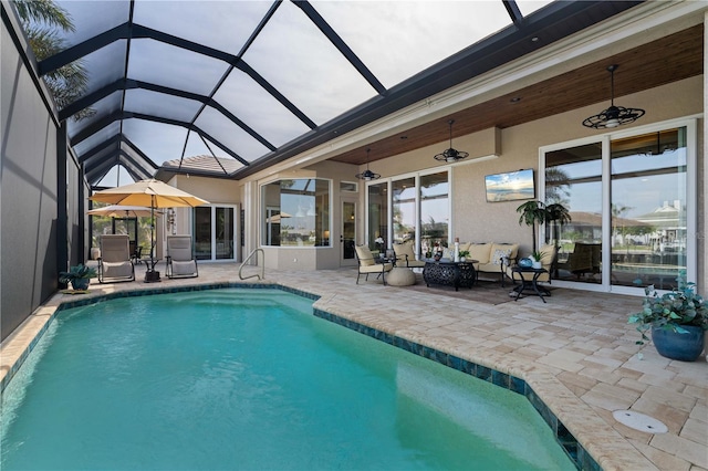 outdoor pool with a lanai and a patio area