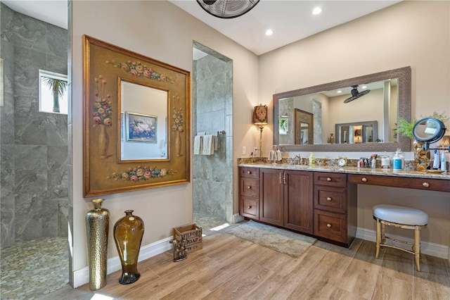 full bath featuring a walk in shower, vanity, wood finished floors, baseboards, and recessed lighting