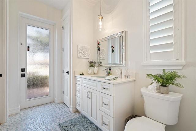 bathroom featuring toilet and vanity