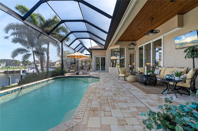 outdoor pool featuring outdoor lounge area, a lanai, a water view, and a patio
