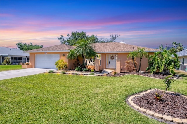ranch-style home featuring a front yard, driveway, stucco siding, and an attached garage