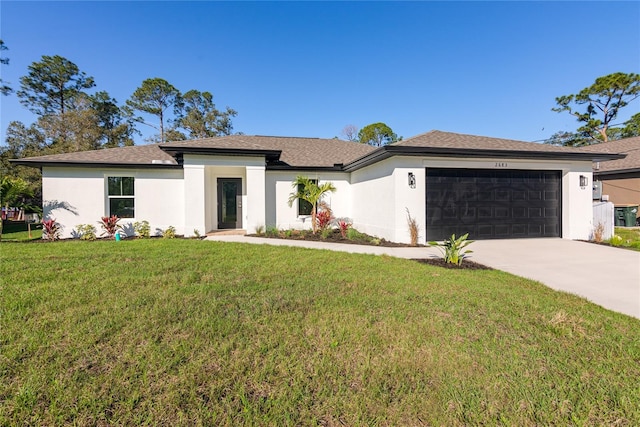 1589 Boswell St, North Port, FL 34288 - prairie-style house featuring a garage, stucco siding, driveway, and a front lawn