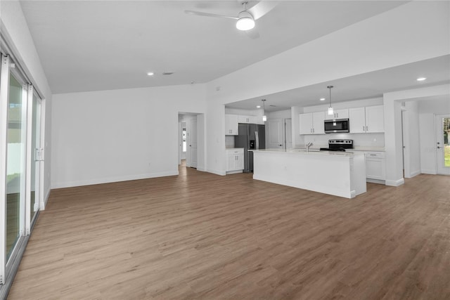 1589 Boswell St, North Port, FL 34288 - unfurnished living room with a sink, ceiling fan, light wood finished floors, baseboards, and recessed lighting