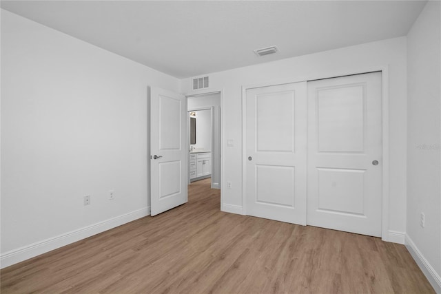 1589 Boswell St, North Port, FL 34288 - unfurnished bedroom with light wood-type flooring, baseboards, and a closet