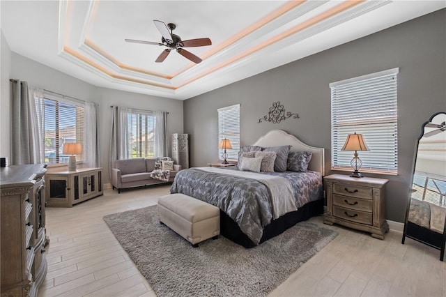347 Portofino Dr, Punta Gorda, FL 33950 - bedroom with a raised ceiling, crown molding, light wood finished floors, and a ceiling fan