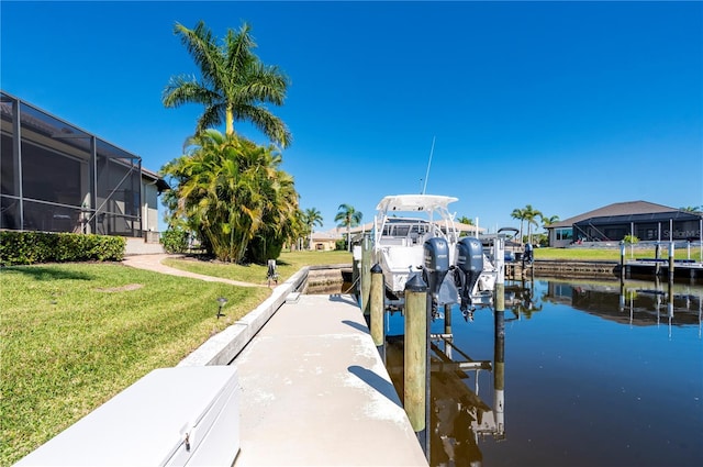 347 Portofino Dr, Punta Gorda, FL 33950 - dock area featuring boat lift, a lawn, a water view, and a lanai