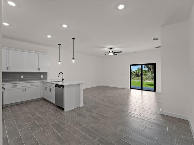 14449 Appleton Blvd, Port Charlotte, FL 33981 - kitchen featuring dishwasher, a peninsula, a ceiling fan, backsplash, and light countertops