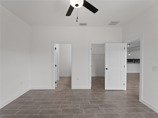 14449 Appleton Blvd, Port Charlotte, FL 33981 - unfurnished bedroom with a spacious closet, wood finished floors, and ceiling fan