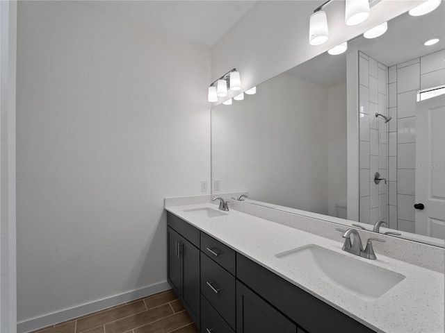 14449 Appleton Blvd, Port Charlotte, FL 33981 - bathroom with double vanity, wood tiled floors, and tiled shower