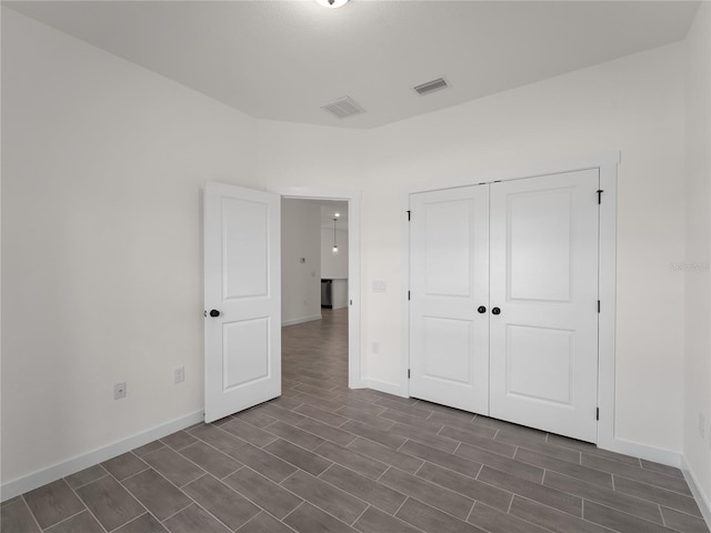14449 Appleton Blvd, Port Charlotte, FL 33981 - unfurnished bedroom with dark wood-style floors and a closet