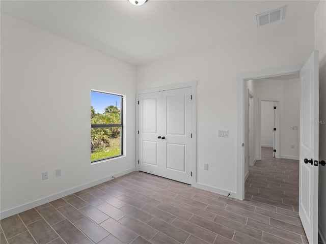 14449 Appleton Blvd, Port Charlotte, FL 33981 - unfurnished bedroom featuring a closet and wood finished floors