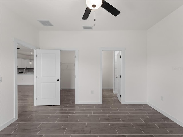 14449 Appleton Blvd, Port Charlotte, FL 33981 - unfurnished bedroom featuring a spacious closet, dark wood-style flooring, and a ceiling fan