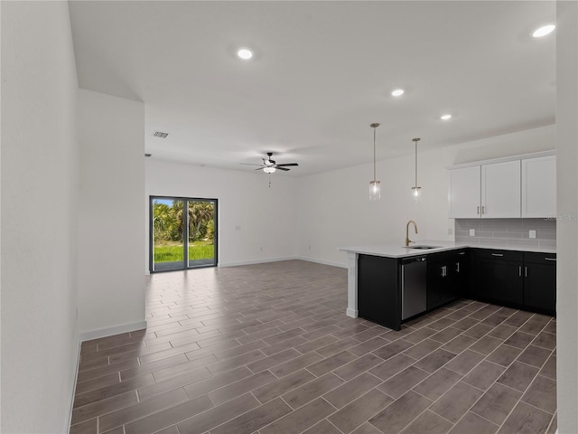 14449 Appleton Blvd, Port Charlotte, FL 33981 - kitchen with dishwasher, a ceiling fan, a peninsula, open floor plan, and white cabinetry