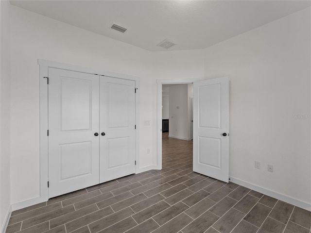 14449 Appleton Blvd, Port Charlotte, FL 33981 - unfurnished bedroom featuring wood tiled floors and a closet