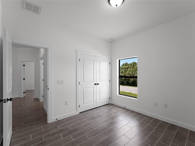 14449 Appleton Blvd, Port Charlotte, FL 33981 - unfurnished bedroom with wood tiled floors and a closet