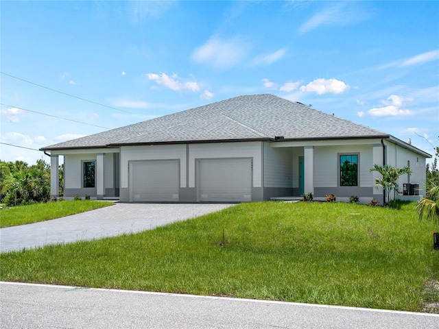 14449 Appleton Blvd, Port Charlotte, FL 33981 - view of front of home with a garage, a front lawn, driveway, and stucco siding