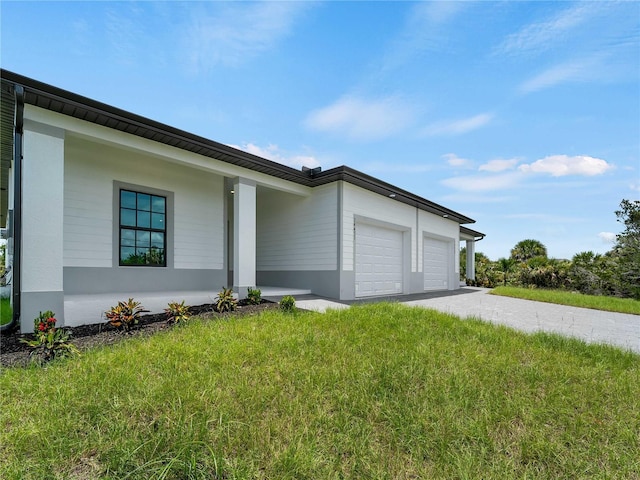 14449 Appleton Blvd, Port Charlotte, FL 33981 - view of side of property featuring a garage, driveway, and a lawn