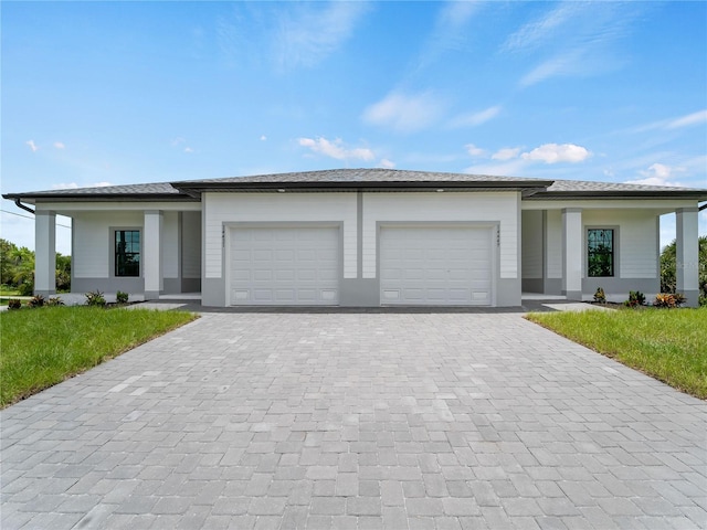 14449 Appleton Blvd, Port Charlotte, FL 33981 - prairie-style house featuring an attached garage, decorative driveway, and a front lawn