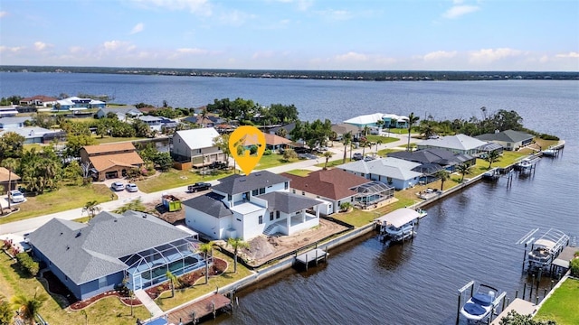 drone / aerial view featuring a residential view and a water view