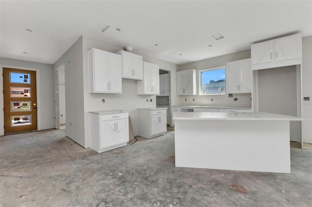 kitchen with a center island and white cabinetry