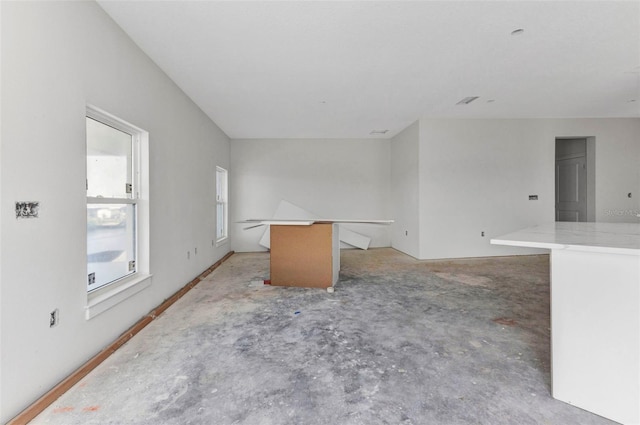 spare room with unfinished concrete floors