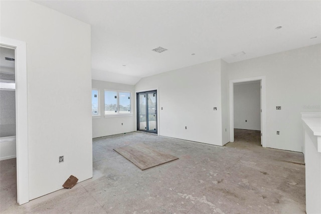 unfurnished living room with vaulted ceiling and visible vents