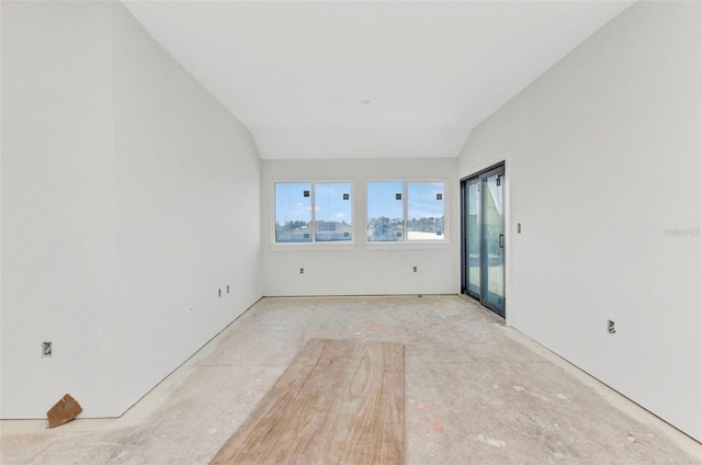 unfurnished room featuring lofted ceiling