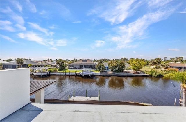 dock area with a residential view and a water view