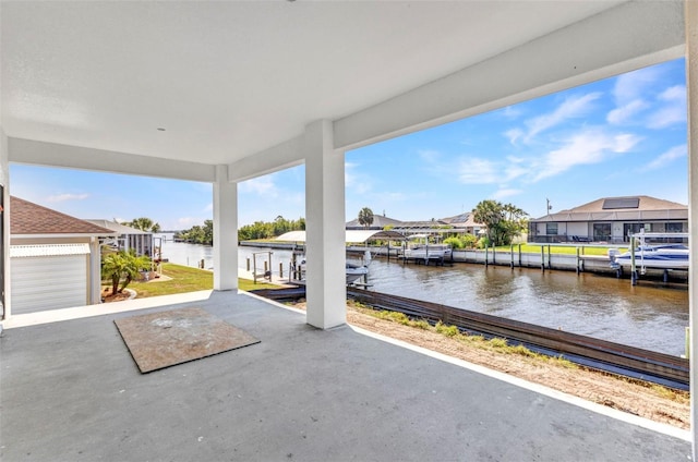 view of patio with a dock, a residential view, and a water view