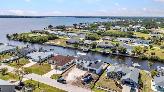 birds eye view of property with a water view and a residential view